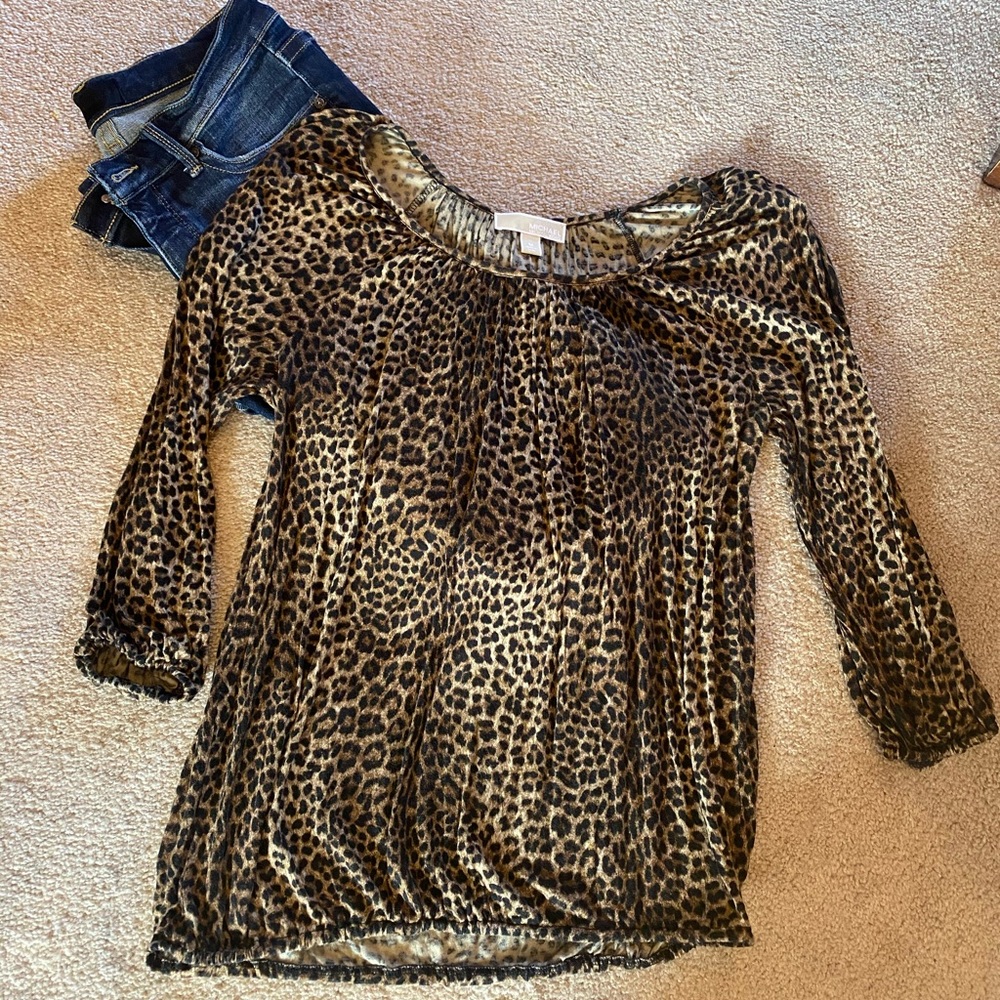 Animal print top. Elastic around wrist area and banded at the waist.
